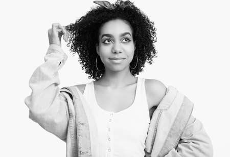 Sensual portrait of glamor elegant black hippie teenage girl model with curly hair isolated on white studio backgroundの写真素材