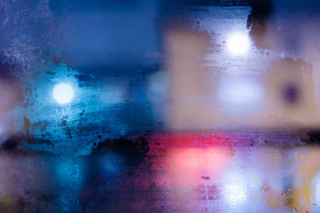 abstract texture night city behind the wet glassの写真素材