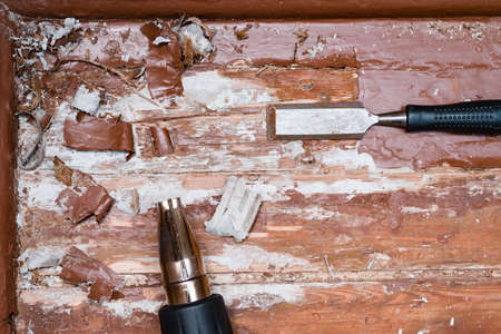 removing paint from the floor with a hot air gun repair tools chisel debrisの写真素材