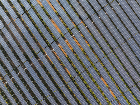Aerial view of solar power plant with many rows of solar panels.の写真素材