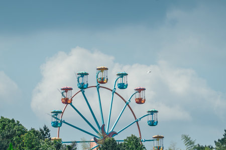 Carnival ferris wheel on blue sky background