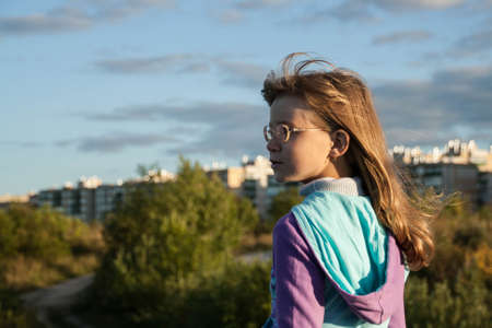 Portrait of a smiling girl in a natural blue sky の写真素材