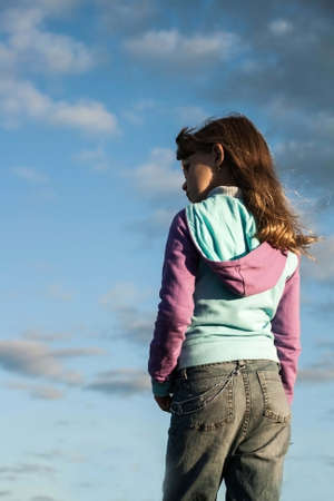 Portrait of a smiling girl in a natural blue sky の写真素材