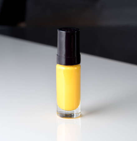 yellow nail polish bottle isolated on white background