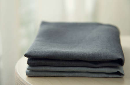 Manufactures industrial textile - grey towels pile isolated on wooden backgroundの写真素材