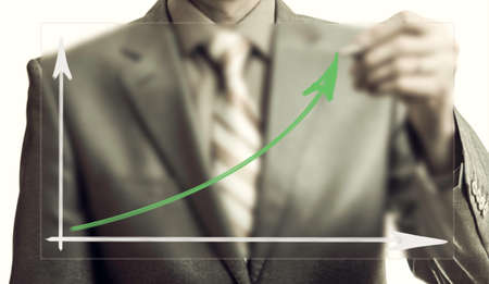 business concept. Businessman drawing growth graph on the glassの写真素材