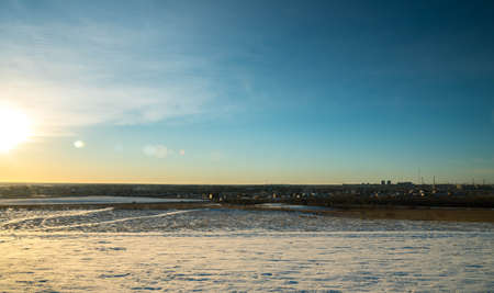 frosty winter day in the village on a background of blue skyの写真素材