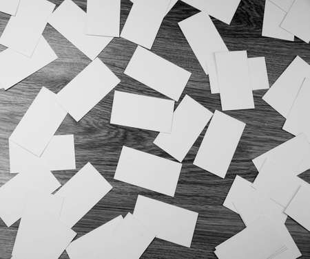 Cwhite sheets of paper scattered on a wooden tableの写真素材