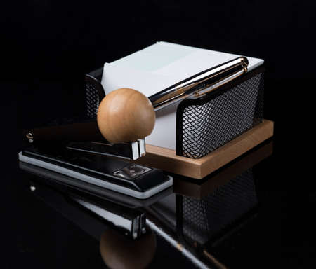 wooden stationery set with silver pen isolated on a dark backgroundの写真素材