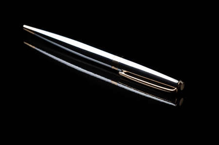 classic silver pen isolated on a black backgroundの写真素材