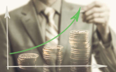 Businessman drawing rising graph, development and growth concept
