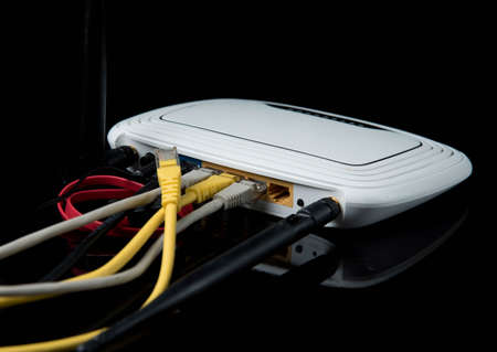 router with wires, cable, Internet, isolated on dark backgroundの写真素材