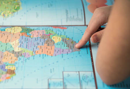 Young tourist couple looking at world map will travelの写真素材