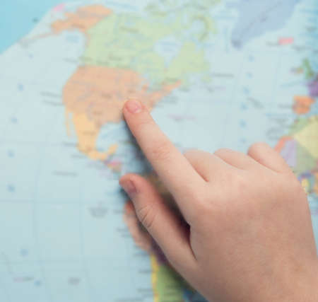 Young tourist couple looking at world map will travelの写真素材