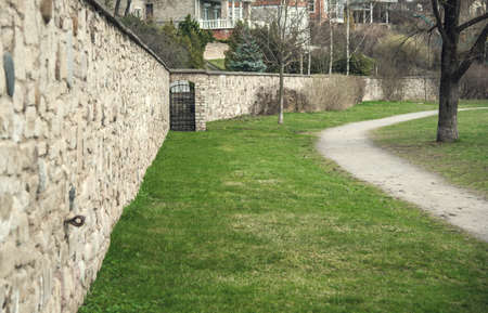 path in a Park on a background of green spring grass