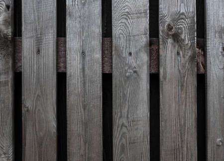 Part of  a wooden gate with a metal ring handleの写真素材