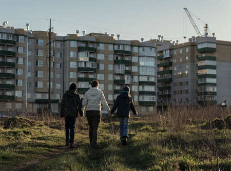 Mother, son and daughter walk in the park in the springの写真素材