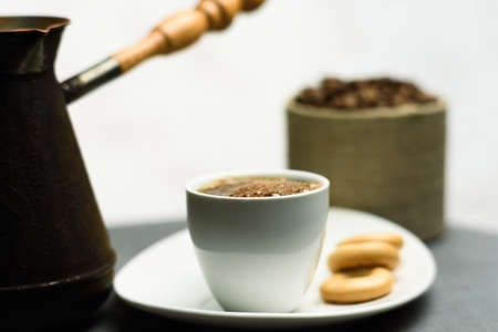 Cup of coffee, a Turk and grains on a gray backgroundの写真素材