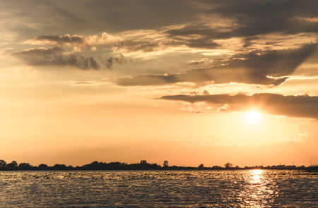 summer sunset on the lake after the rainの写真素材