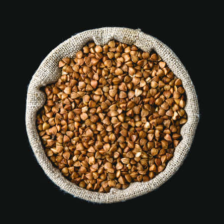 buckwheat in a linen sack isolated on black backgroundの写真素材