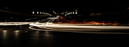 night traffic in the city and blurry lights from the headlights of carsの写真素材