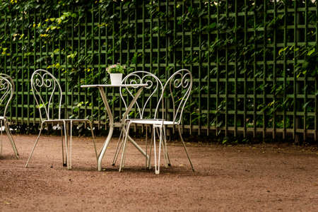 Modern set of white tables in the Park cafe in the rainの写真素材