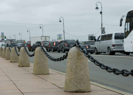 sidewalk with a fence on the background of city trafficの写真素材