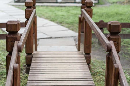 wooden bridge in Park on a background of green grassの写真素材