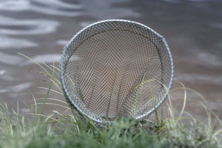 ishing tank in the background of the river and green grass