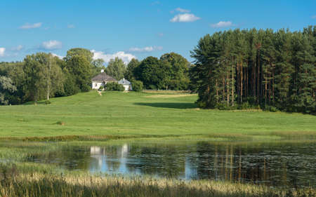 summer landscape of green hills on the background of the riverの写真素材