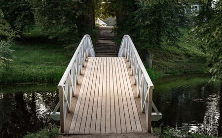 wooden bridge in Park on a background of green grassの写真素材