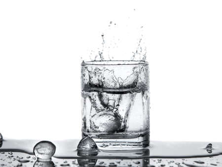 water splash with ice in glass isolated on the white background