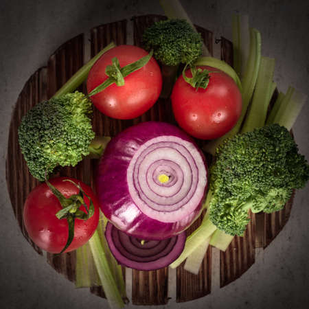 view from the top cover vegetables on a wooden platter on a dark backgroundの写真素材