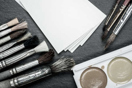 Mockup with a sketchbook, paints and brushes for drawings or designsの写真素材