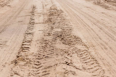 Tread marks on the dry rural sandy roadの写真素材