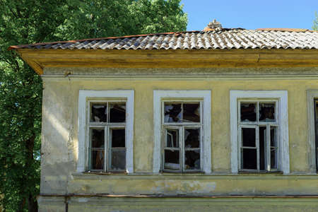 Broken windows of an abandoned buildingの写真素材