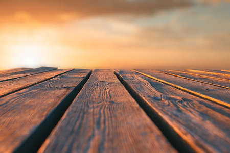 Close up top wooden table and blur sunset backgroundの写真素材