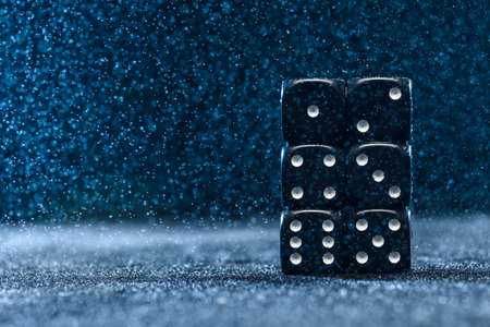 Six black different dice on a blue background. The concept of gambling. Cubes from one to six.の写真素材