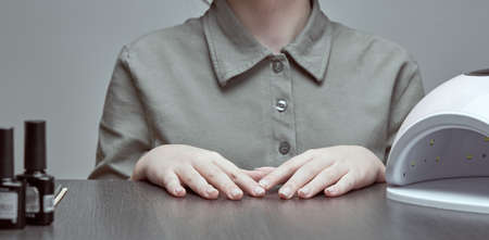 Female hands and manicure accessories on the table.の写真素材