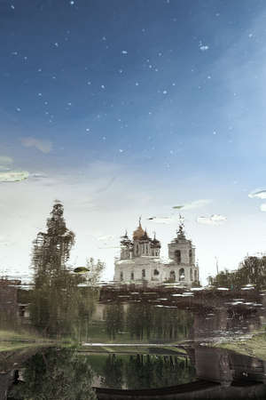 Reflection in water of the Trinity Cathedral of the Pskov Kremlin on sunny day.の写真素材