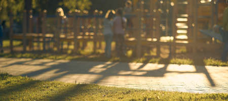 Horizontal blur shot of children's Playground with children of the bright sunlight.の写真素材