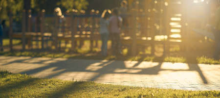 Horizontal blur shot of children's Playground with children of the bright sunlight. Abstract Park background.の写真素材