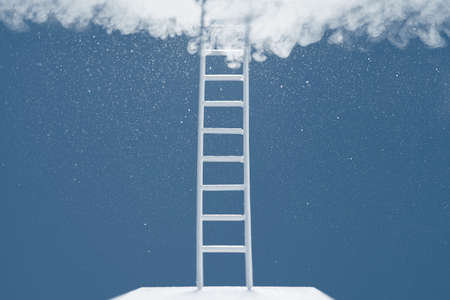 Ladder reaching into a blue sky and clouds. The concept of the path to success.の写真素材