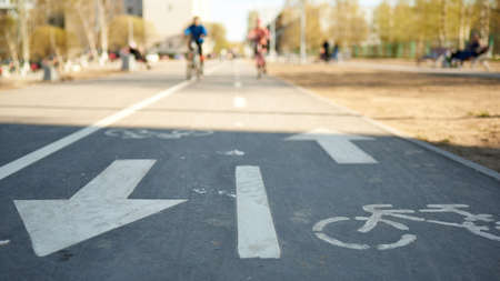 Horizontal shot of bike path against the background of cyclists in a blur.の写真素材