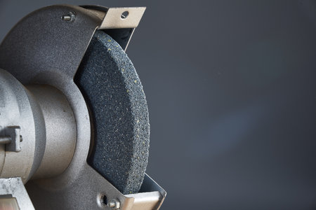 Abrasive emery for sharpening tools close up on gray background.