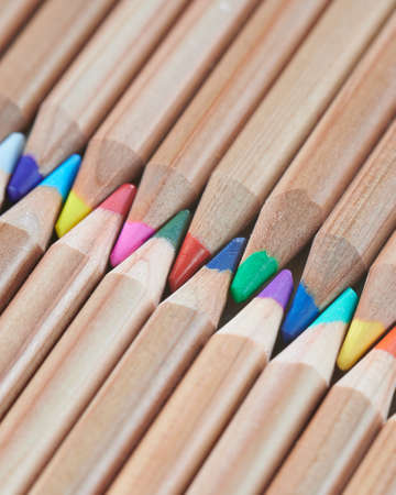 Exactly laid out colored wooden pencils. Background new pencils.