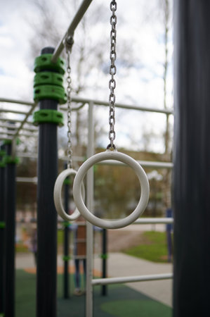 Vertical shot of gymnastic rings on outdoor sports field. The background in blur.の写真素材