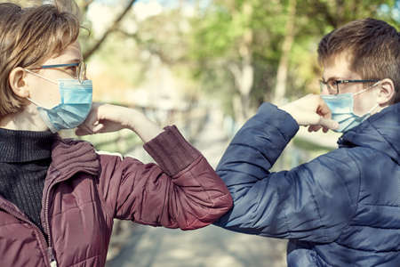 Friends guy and girl demonstrating a new way of greeting during coronavirus epidemic.の写真素材