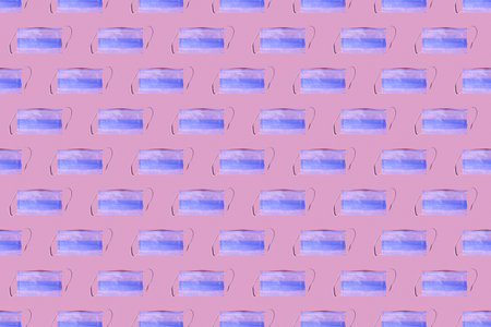 Seamless pattern of many medical masks on the pink colored background to cover the mouth and nose for protection from virus and bacteria on a pink background. Epidemic concept.の写真素材