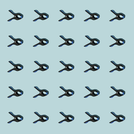 Pattern of black multipurpose clamps with blue grips. Vertical orientation. Blue background.